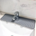 Dettaglio del tappetino drenante in silicone grigio con trama a onde su lavandino bianco - Silicone / Grigio Medio