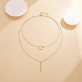 Detail of a double-layer gold geometric necklace with circular and vertical bar pendants - 925 Silver / Gold