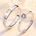Close-up of couples rings with heart-shaped stone and Endless Love engraving - Adjustable Open / Men's and Women's Pair Set