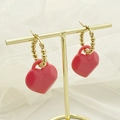 Sweet red acrylic heart earrings with golden beaded hoops on an elegant display - Pink