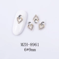 Macro detail of 6x9mm V-shaped heart nail art jewelry with teardrop crystal and gold base - Gold Base Clear Rhinestone (8961)