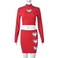 Detail of red ribbed crop top and mini skirt set with rhinestone heart cut-outs - S / Red