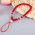 Macro shot of red beaded phone charm strap with sparkling crystal spheres and floral accents - K6279 Crystal Phone Chain Red / Phone Chain
