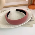 Close-up of thick vintage dusty rose velvet headband on a decorative white ceramic plate - Korean Pink