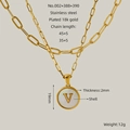 Double-layered 18k gold plated necklace featuring a round white shell pendant with letter V - Letter V