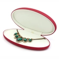 Red oval PU leather jewelry box with white velvet lining and emerald green necklace - Red Necklace Box