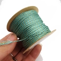 Detailed view of 1mm teal and gold metallic twisted thread roll for DIY jewelry making - Lake Blue