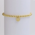 Detail of a golden beaded stretch bracelet featuring a round letter N initial pendant - Letter N (DB240603-N)