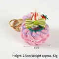 Pink donut keychain with green bow and strawberry charm, 4.5cm wide and 42g weight - 042 Purple (Green Bow) - Gold 8-clasp