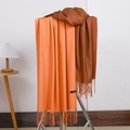 Soft cashmere tassels scarf in orange and brown colors displayed on a wooden stand - No.10 Orange