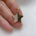 Macro shot of gold-plated star pendant with cubic zirconia inlay and polished finish - Pentagram