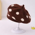 Detail view of brown knitted beret with white polka dots on a white display stand - 1-3 Years / Coffee