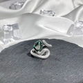 Detail of silver snake ring with green enamel and clear gemstone on dark stone base - No. 18 Open Ring