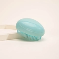 Portable light blue egg-shaped detangling brush with soft bristles for easy hair styling - Solid Green