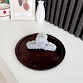 Plush hair claw clip with grey and light green color-block design on a wooden tray - Grey + Green