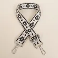 Detailed shot of beige and black star-patterned strap with silver metal hooks - Beige Black Silver Hook