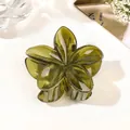 Close-up of olive green flower claw clip with translucent resin petals and sturdy teeth - Jelly Forest Green