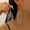 Macro shot of silver layered spiral leaf earrings with intricate hollow metal design - Spiral Leaf Shape / White Gold