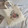 Off-white canvas tote bag featuring a Christmas snowman and cabin illustration - C13 Christmas Snowman Globe