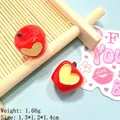 Macro detail of 3D red resin apple charms with yellow heart accents for DIY crafts - Small Heart Apple