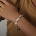 Two-tone gold and silver watch-band style stainless steel bracelet on a wrist - 10mm Width / Two-tone (Gold & Silver)