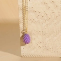 Elegant purple enamel egg pendant necklace with golden spiral details on a gold chain - Purple