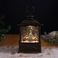 Close-up of bronze vintage Christmas lantern with internal house scene and swirling snow - Forest House