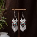 Close-up of Bohemian earrings with silver metal feathers and colorful ethnic beads - Red Blue and Silver (E1222-4)