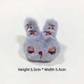 Detail shot of a grey plush rabbit accessory with cherry embroidery, sized 5.5cm x 5.5cm - Gray