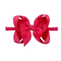 Detail view of a pink ribbed nylon headband with a large bow for infants and toddlers - Pink