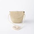 Detail of a beige straw crossbody bag with round flap and woven strap on white background - Beige Flip Bag (15*13cm)