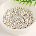 18K gold-plated silver wheel beads for DIY jewelry making in a white ceramic bowl - Bright Silver
