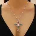 Macro view of cross pendant with colorful crystals, pink heart stone and pearl chain - Silver Pink Heart Cross Pearl Chain (DZ-493)