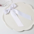 Elegant white satin double-layered bow hair clip on a decorative lace ceramic plate - White