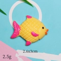 Detail view of a yellow and pink fish resin accessory measuring 2.6x3cm for DIY crafts - Yellow Turbot