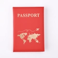 Close-up of red PU leather passport holder with gold world map and passport engraving - Red
