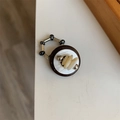 Detail of vintage beaded stretch ring with brown base, white shell, and silver metal beads - Style I Coffee