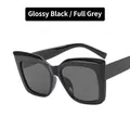Glossy black cat eye sunglasses with full grey lenses and a thick oversized frame - Bright Black / Gray