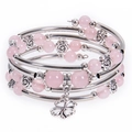 Detailed shot of pink beaded multi-layer bracelet with rose accents and clover charm - Rose Quartz