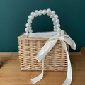 Handmade woven rattan handbag with elegant pearl handle and white ribbon bow detail - Trapezoid with Hard Handle