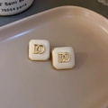 Square gold rimmed stud earrings with white leather inlay and interlocking DD logo - Square Letter Style / Off-white Letters