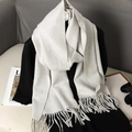 Light beige cashmere feel scarf with fringe tassels shown in an aesthetic autumn setting - Light Beige