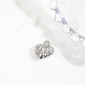 Detailed view of a silver shell-shaped pendant with hollow design and smooth metallic finish - 21*15mm Pumpkin Shell Pendant / Silver