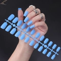 Detail of matte blue long square press-on nails on a model and product frame - Matte Blue