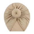Detail of beige soft cotton baby donut hat with decorative top knot bun texture - Light Coffee