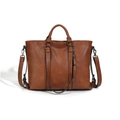 Detail view of large brown soft leather tote bag with vertical straps and side zip pocket - Brown