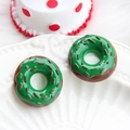 Detailed close-up of chocolate donut resin charms with green icing and red stripes - Donut-Christmas Green