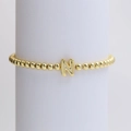 Elastic gold beaded bracelet featuring a polished 18k gold-plated letter N charm - Gold N