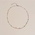 Colorful beaded stainless steel necklace with S925 stamp on a warm beige background - White Gold