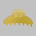 Close-up of a large yellow acetate hair claw clip with a glossy translucent finish - Transparent Yellow